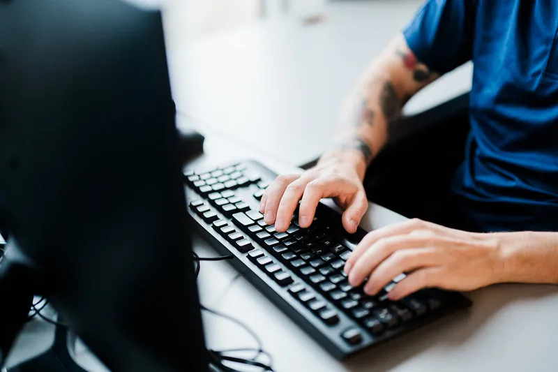 Professional working on laptop with cybersecurity focus